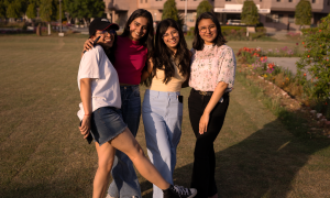 Smart Casual Style Guide for Women Smiling friends posing together in a park during a warm sunny day, showcasing vibrant styles and camaraderie.