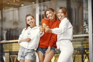 Smart Casual Style Guide for Women Three teenage girls having fun with ice cream cones in a joyful outdoor setting.