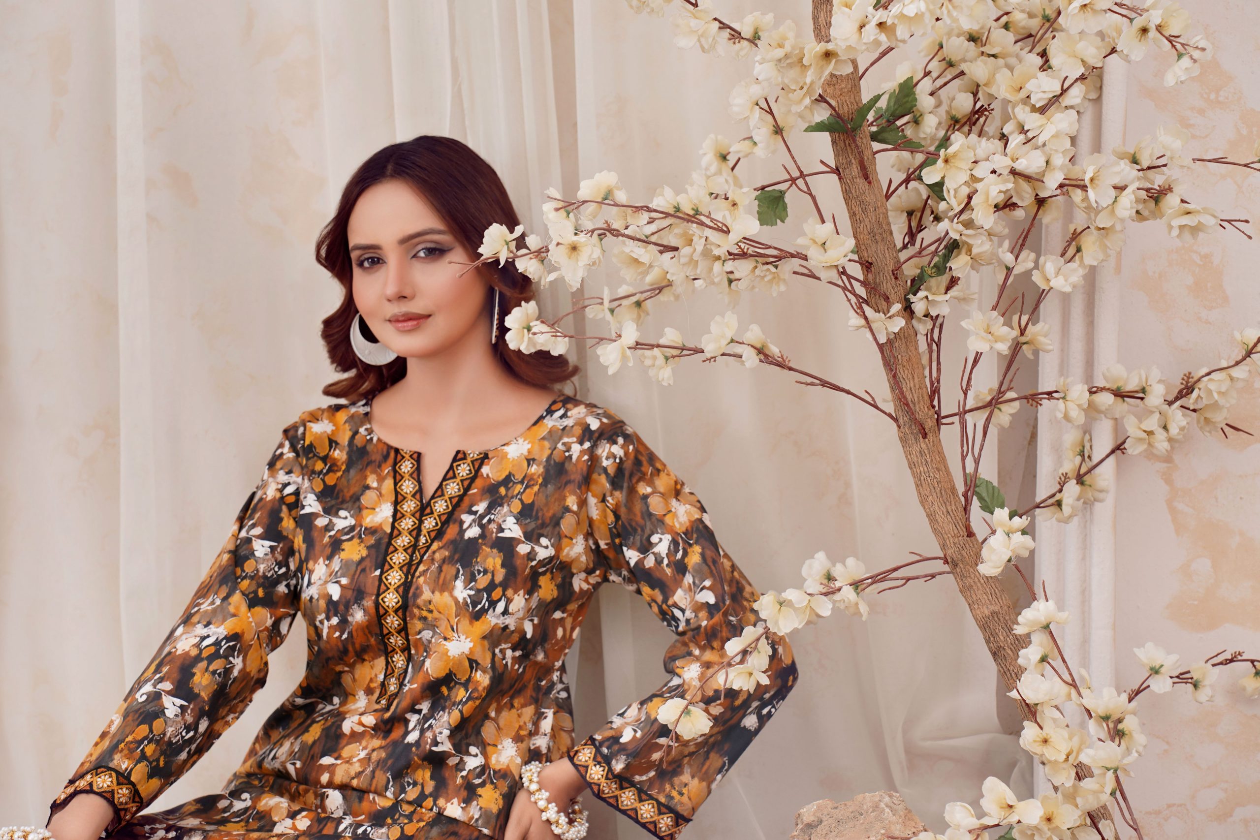 A stylish portrait of a woman in Pakistani attire with floral decor, captured in Lahore.